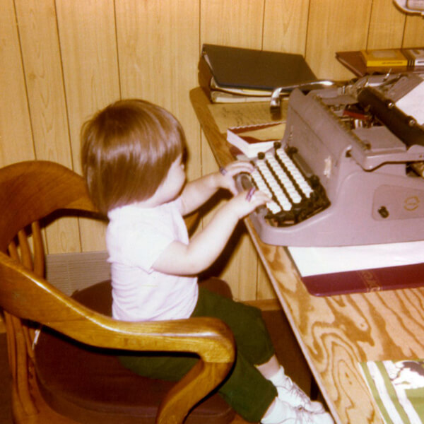 Irene at 2-years old typing on an old typewriter
