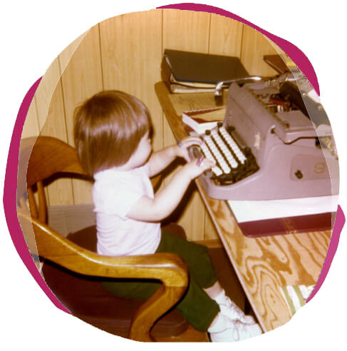 Irene at 2-years old typing on an old typewriter